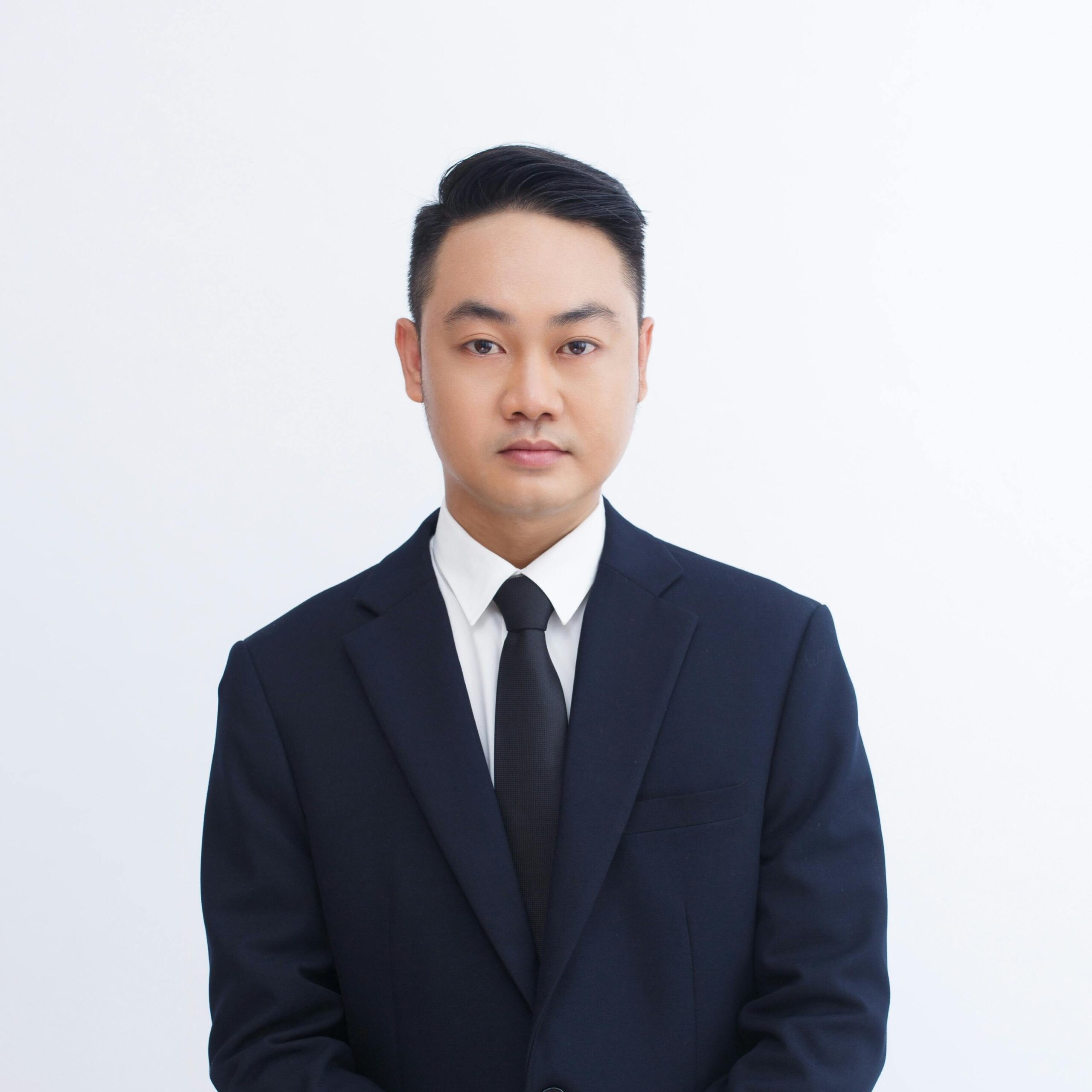 Elegant portrait of an adult businessman in a dark suit, posing with a confident expression.